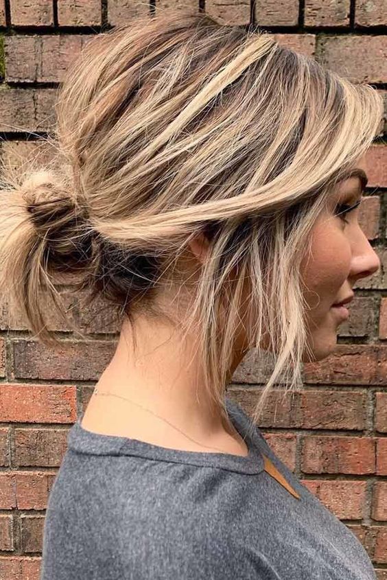 a casual updo on short hair, a low messy bun with a messy top and some hair down is a cool idea you can make on the go