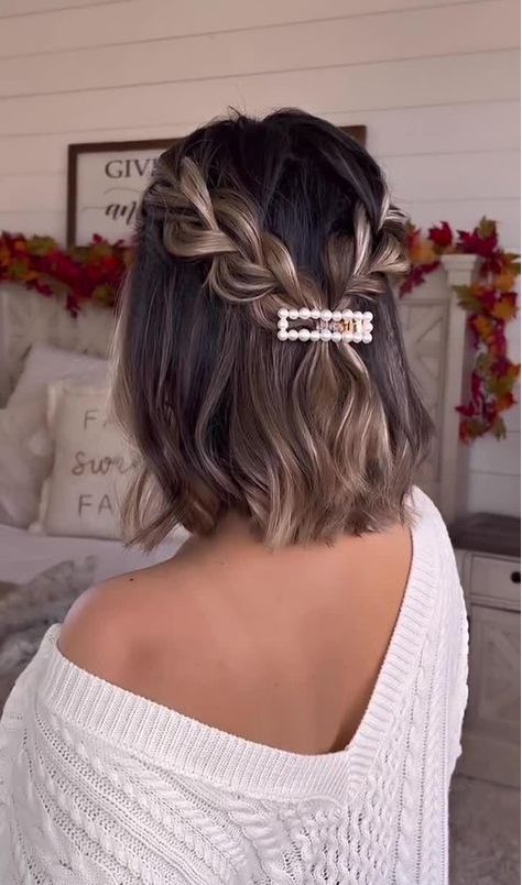 a catchy half updo with braids, waves and a pretty pearl hair piece is a lovely solution for a holiday party