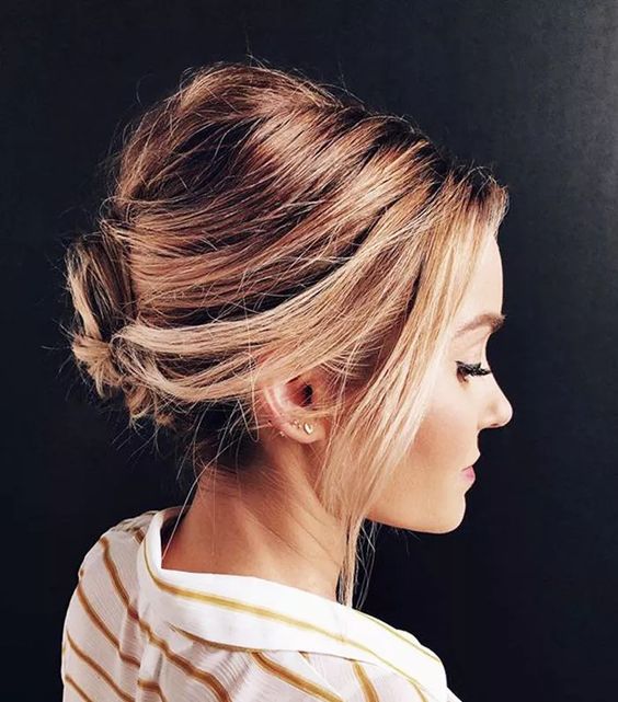 a catchy messy updo with a bump on top and face-fraing hair is a lovely idea to rock