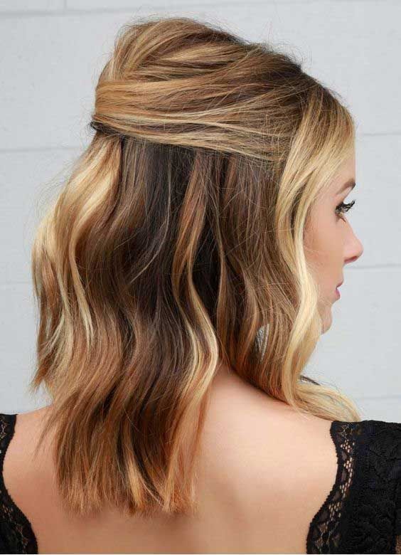 a chic and sexy half updo with a bump on top and wavy hair down is a cool solution for a party