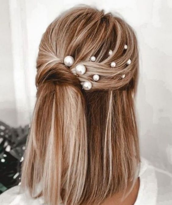 a chic twisted half updo with multiple pearl hair pins and straight hair down is a cool idea