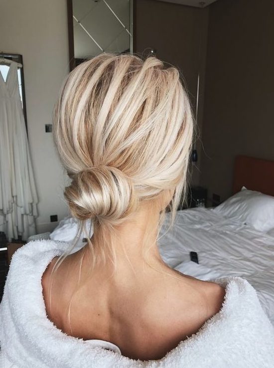 a classic low bun with a volume on top and some locks down is a cool idea for a modern look