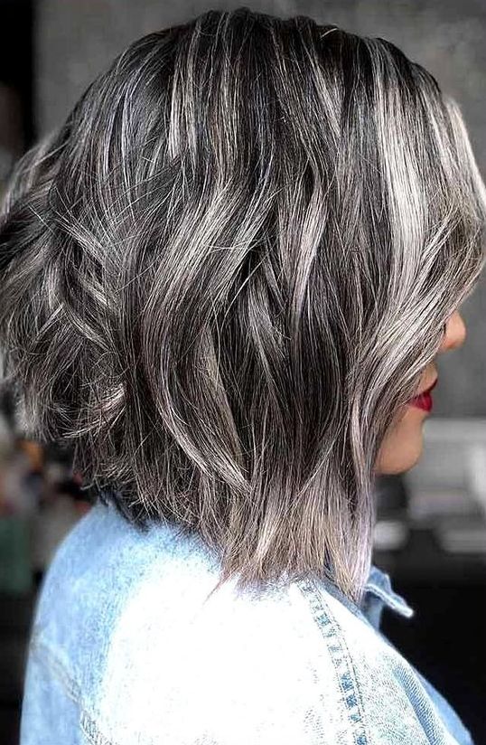 A cool A line black bob with silver grey balayage that hides naturally grey hair is a cool and chic way