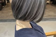 a dark, almost black midi bob with grey highlights that include naturally grey hair, too