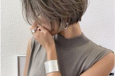 a dark midi bob with grey highlights and naturally grey hair that add interest and a bold touch