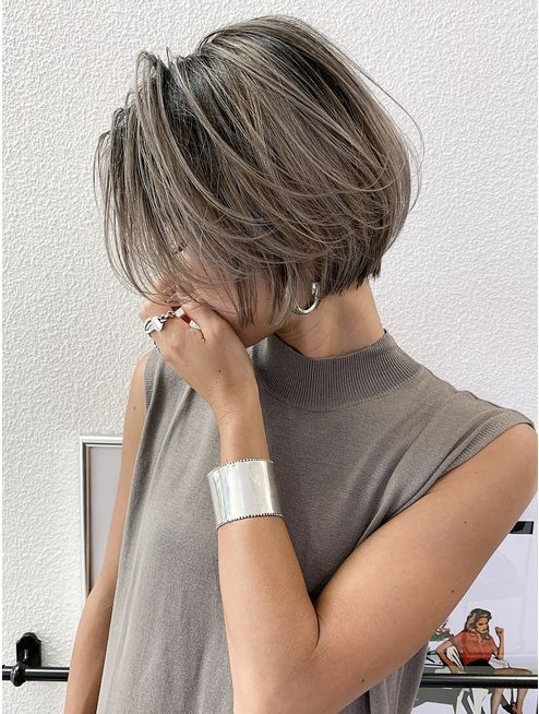 a dark midi bob with grey highlights and naturally grey hair that add interest and a bold touch