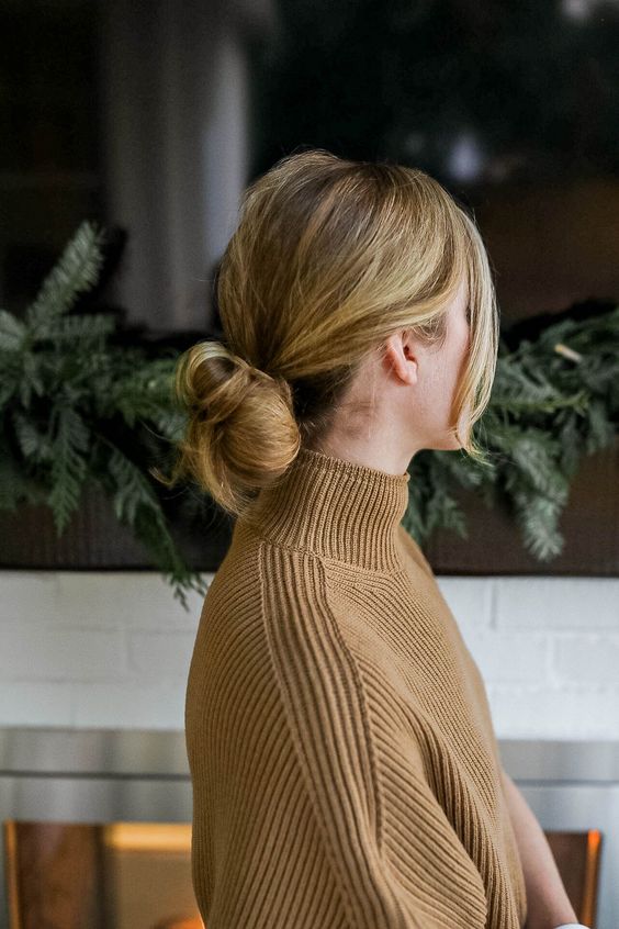 a fast and casual low bun hairstyle wih a bump on top and face-framing hair is a super cool and chic solution
