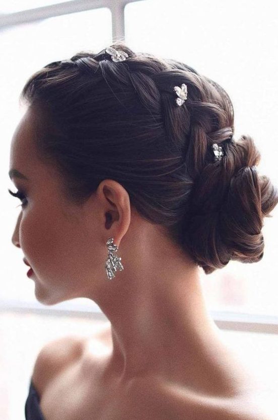 a glam updo with a braid on top and a low bun accented with rhinestone hairpins is a cool and catchy idea for holidays