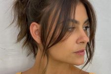 a high messy and wavy ponytail and side bangs are a cool and catchy idea for an every day look