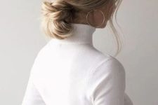 a knotted low bun with a volumetric top and face-framing hair is a cool and chic idea to rock and to try