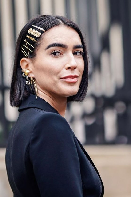 a long black bob with a whole arrangement of gold and pearl hair pins is a cool and catchy idea for a modenr holiday look