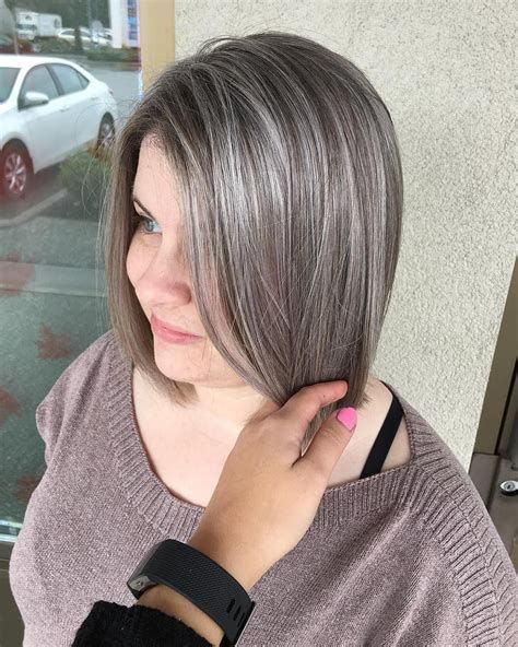 a long brown bob with silver grey balayage and naturally sivler grey hair looks very stylish