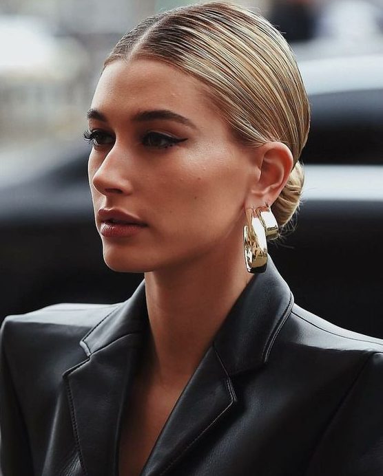 a low bun with a super sleek top paired with statement earrings is a timeless and very refined idea for any party