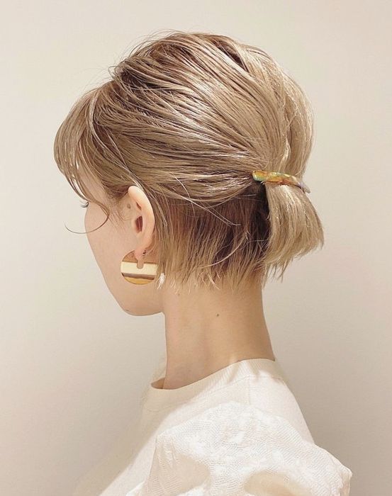 A low ponytail with a barrette, with a bump on top and some face framing hair is amazing