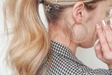 a low ponytail with a bump on top and waves, with celestial hair pins is a cool and catchy hairstyle for the holidays