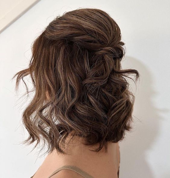 a medium half updo with a bump and twists plus waves down is a stylish and chic idea for many parties