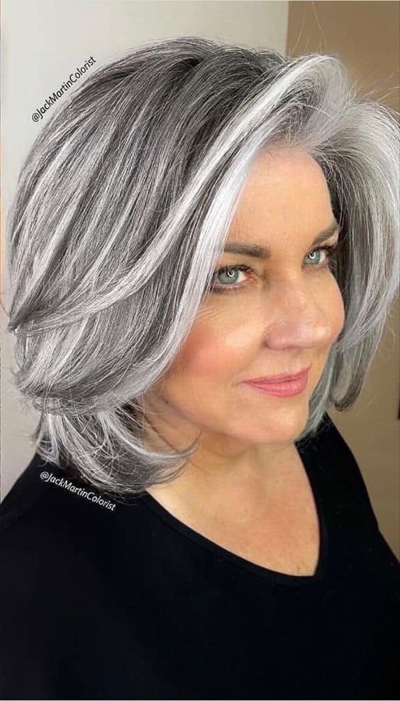 a medium-length butterfly haircut in black with silver grey balayage and money piece plus curled ends is wow