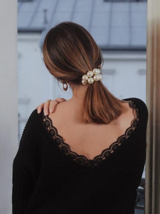 a medium low ponytail with a pearl scrunchie is a catchy and romantic idea for the holidays