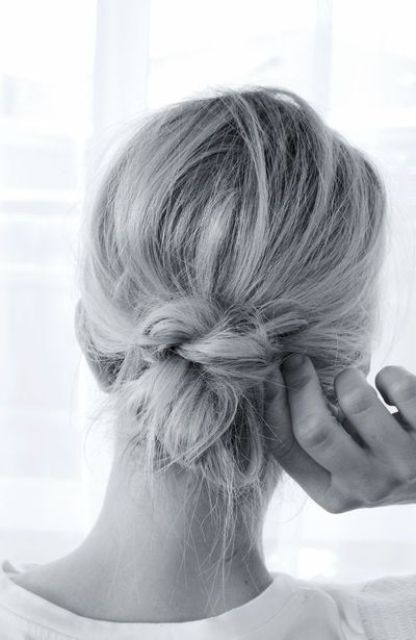 a messy low bun with a messy top and a knot is a cool idea to realize on short hair