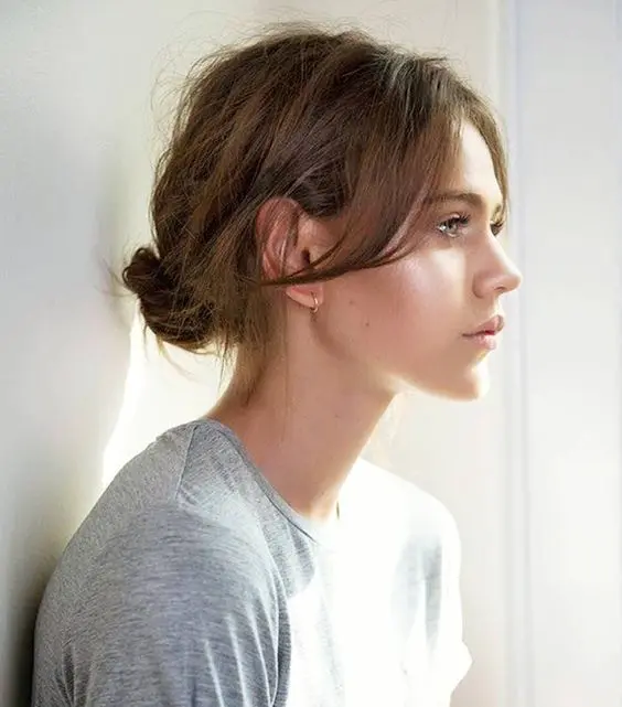 a messy low bun with a messy top is a cool idea you can rock every day