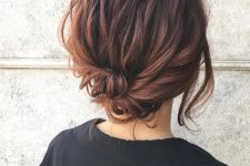 a messy wrapped low updo with wavy hair on top and face-framing hair is a cool and catchy idea to try