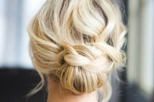 a pretty low updo with a braided touch and a wavy and mess top is a cool solution for a Christmas look