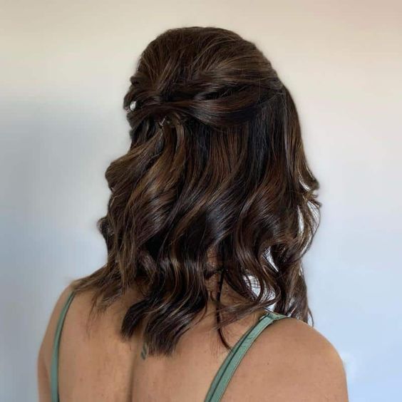 a pretty medium half updo with a bump on top, twists and waves down is a stylish solution to rock