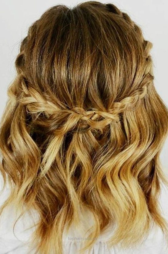 a pretty medium-length half updo with blonde balayage, a braided halo and waves is a cool and catchy idea