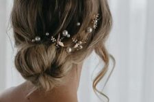 a romantic loose low ballerina bun with some pearl hair pins and flowers is a cool idea, whatever the season is
