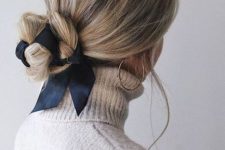 a simple and pretty woven low bun accented with a black ribbon looks very nice, cute and easy to realize