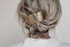 a simple and quick low updo with waves and a beautiful seashell barrette is a cool and quick to make hairstyle