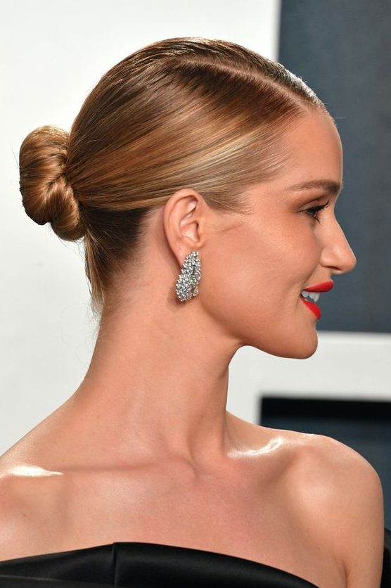 a sleek bun with a slee top and parting is a cool and catchy idea that looks timeless and elegant