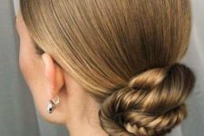 a sleek top plus a fishtail braid low bun is a cool and chic solution for a modern and beautiful look