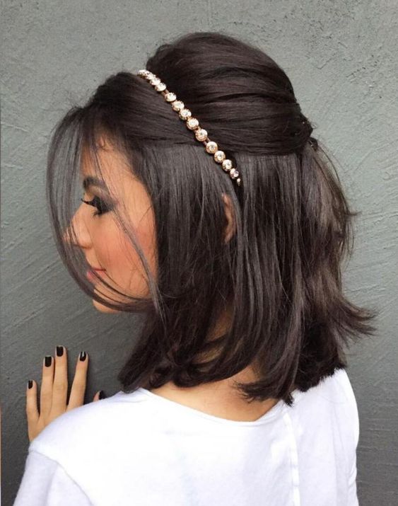 a stylish half updo with a bump on top and hair down, face-framing hair and an embellished hair piece for a party