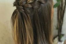 a stylish medium half updo with a chunky braided crown and straight hair down is a cool solution to rock