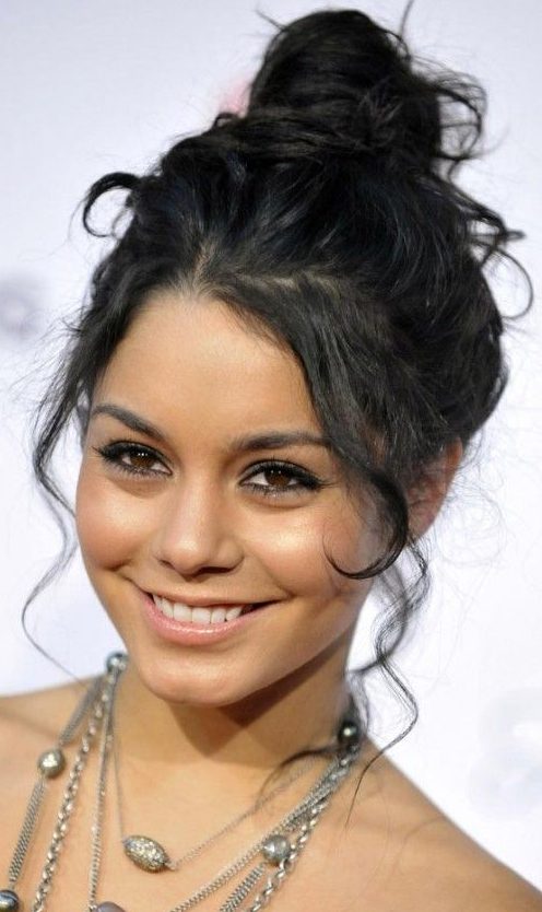 a top knot with curls framing the face and some curls down is a cool idea for an effortlessly chic look