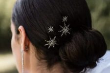 a twisted low bun with a sleek yet voluminous top and celestial hair pins is amazing to rock