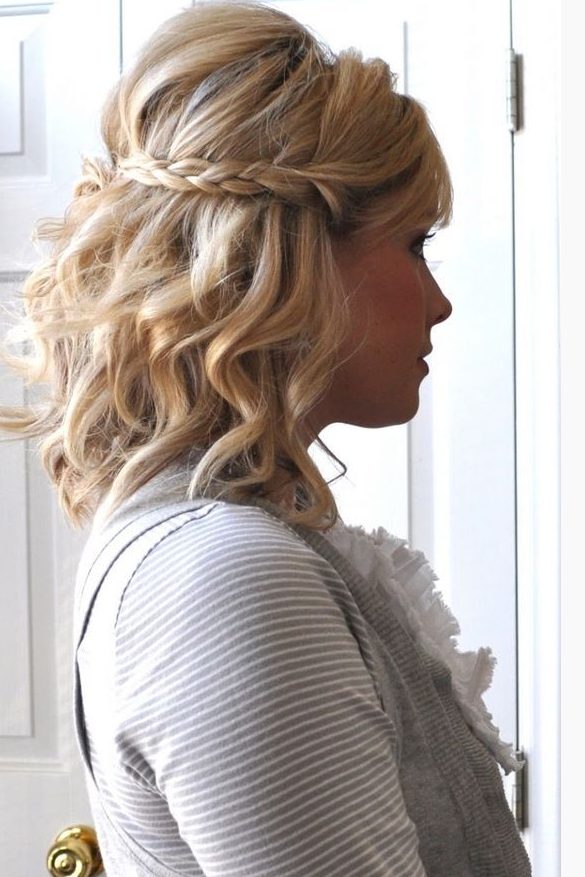 a wavy half updo with a braid and volume on top is suitable for medium length hair