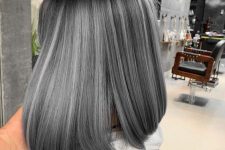 an elegant black long bob with grey balayage and a fringe looks cute and super cool and up-to-date