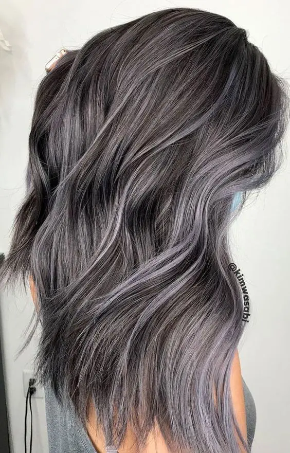 gorgeous long dark hair with grey highlights is a catchy idea to blend your naturally grey hair in