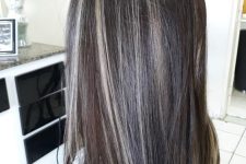 long dark brown hair with grey balayage tha blends with the natural greys looks very chic and catchy