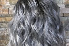 medium-length black hair with a lot of silver grey accents and waves looks amazing and very chic