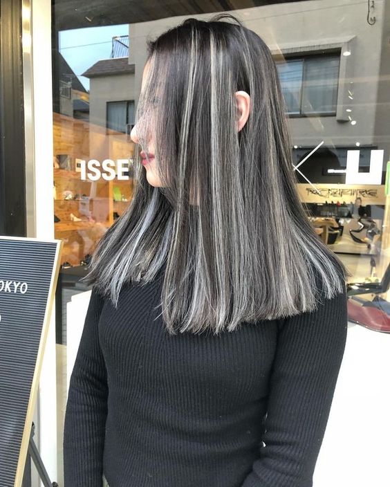 medium-length black hair with silver grey balayage and a lot of volume is a super eye-catchy and chic idea