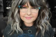 medium-length black hair with silver grey balayage and bottlneck bengs with balayage, too, with waves and volume
