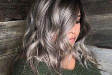 medium-length black hair with silver grey balayage that wows, it looks bold, eye-catchy and very inspiring, and waves add interest