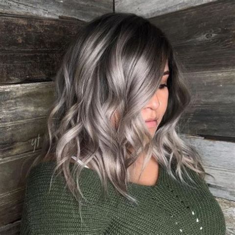 Medium length black hair with silver grey balayage that wows, it looks bold, eye catchy and very inspiring, and waves add interest