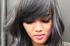 medium-length black hair with silver highlights and waves, with classy side bangs looks very pretty