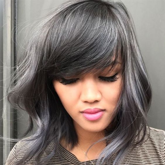 medium-length black hair with silver highlights and waves, with classy side bangs looks very pretty