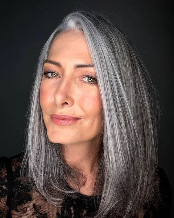 medium-length dark hair with a grey money piece and some grey highlights for a natural and pretty look
