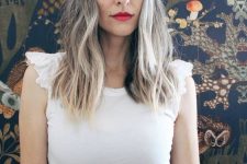 medium-length dark hair with silver balayage and a money piece that is added to the naturally silver grey hair